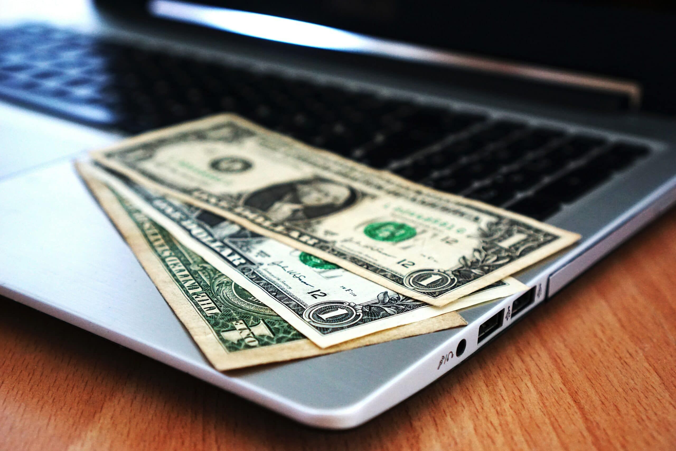 money on laptop - cybersecurity budget, Cyberscore, cybersecurity companies Chicago
