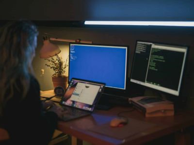 Person on laptop in dark room, Cybersecurity, Ransomware Protection
