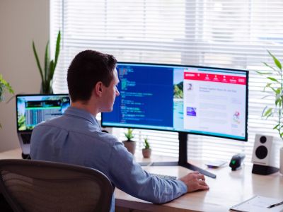 Man sitting at table in front of computer, Cybersecurity, Ransomware Protection