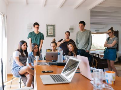 People gathered around a laptop, Cyberscore, cybersecurity companies Chicago