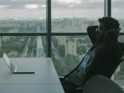 Person sitting at a desk - IT Guy vs Cybersecurity Provider, Cyberscore, cybersecurity companies Chicago