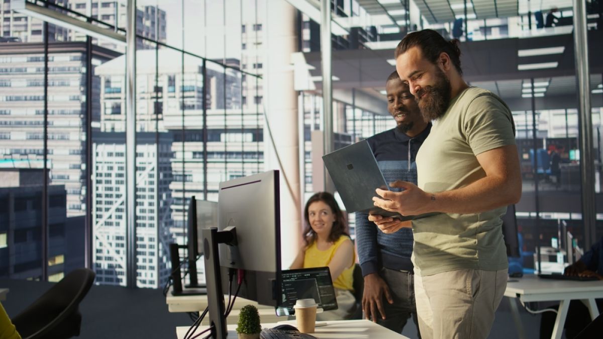 Two men looking at a laptop