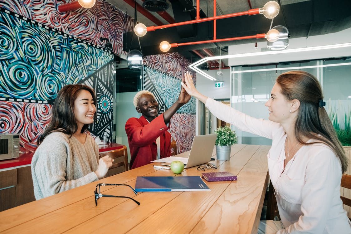 team members high five - cybersecurity measures, Cyberscore, cybersecurity companies Chicago
