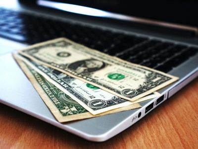 money on laptop - cybersecurity budget, Cyberscore, cybersecurity companies Chicago