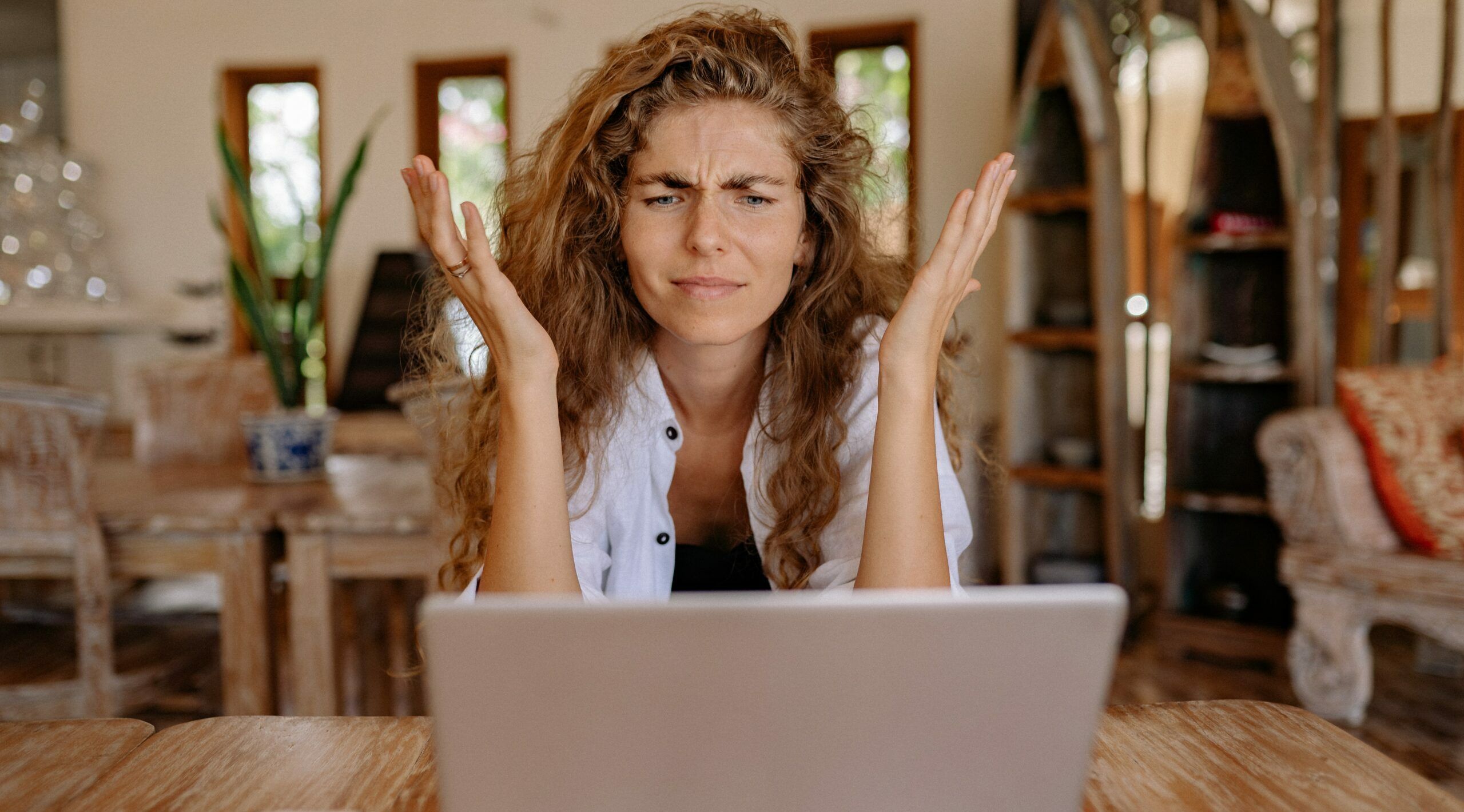woman looking at laptop confused - Why Are Small IT Companies Not Well-Equipped, Cyberscore, cybersecurity companies Chicago
