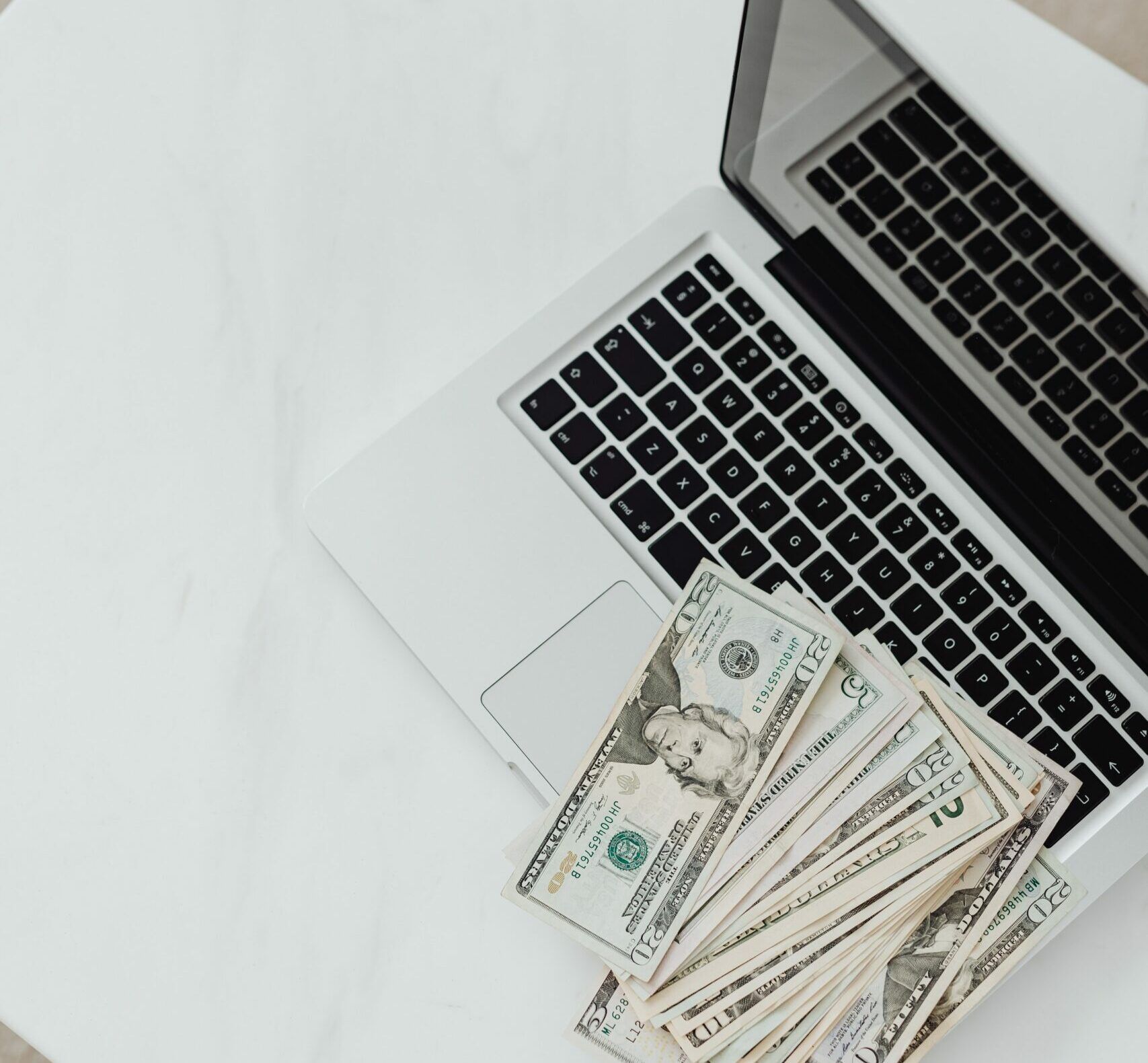 money on laptop - invest in IT Support, Cyberscore, cyber security companies Chicago