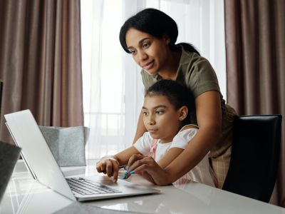 mother and child sitting at table on laptop, Cyberscore, cybersecurity companies Chicago