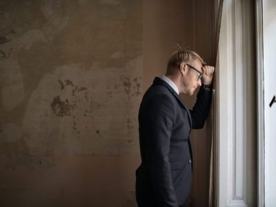 Man standing inside room looking out window, Cyberscore, cybersecurity companies Chicago