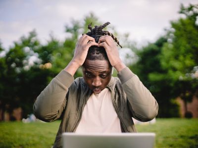 frustrated man looking at his laptop, Cyberscore, cybersecurity companies Chicago