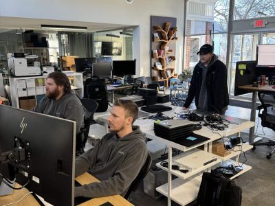 3 LeadingIT technicians working on computers in a bright office